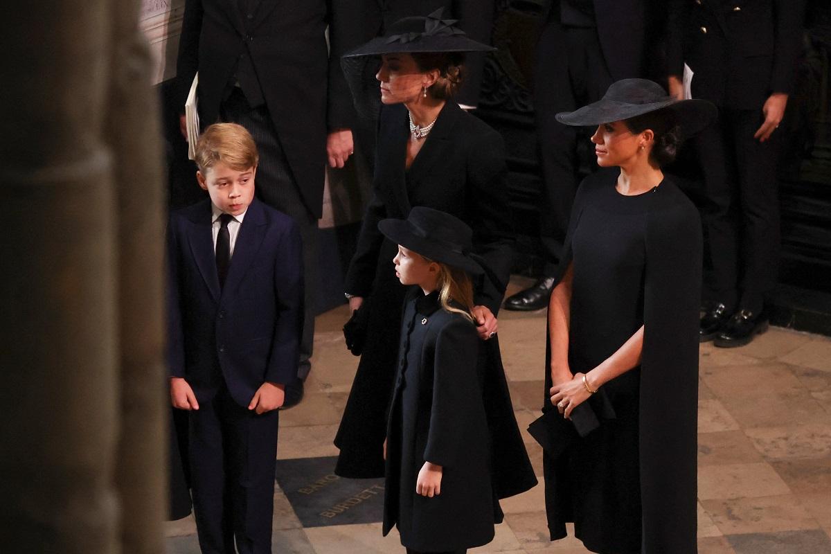 Catherine, Princess of Wales, Meghan, Duchess of Sussex, Prince George and Princess Charlotte attend, on the day of the state funeral and burial of Queen Elizabeth II, at Westminster Abbey in London, Britain, September 19, 2022. REUTERS/Phil Noble/Pool 