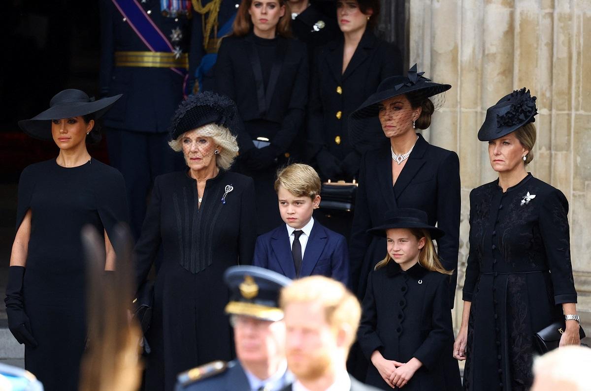 Meghan, Duchess of Sussex, Queen Camilla, Prince George, Princess Charlotte, Catherine, Princess of Wales, Sophie, Countess of Wessex and above them Princess Beatrice and Princess Eugenie of York stand outside Westminster Abbey after a service on the day of the state funeral and burial of Britain's Queen Elizabeth, in London, Britain, September 19, 2022. REUTERS/Hannah McKay/Pool