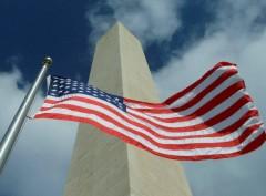 Washington Monument is seen with an American flag