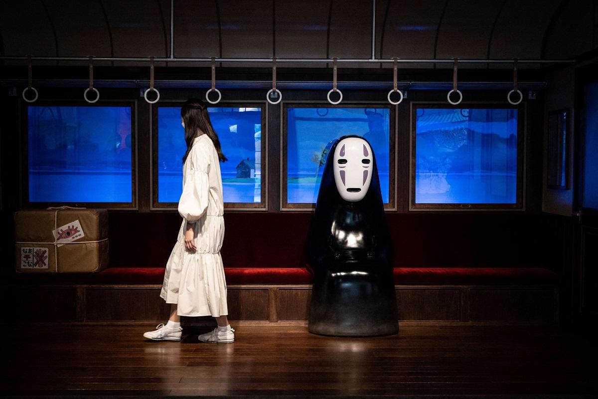 A member of the media looks at a 'Spirited Away' exhibit at Ghibli's Grand Warehouse during a media tour of the new Ghibli Park in Nagakute, Aichi prefecture on October 12, 2022. Yuichi Yamazaki/ AFP