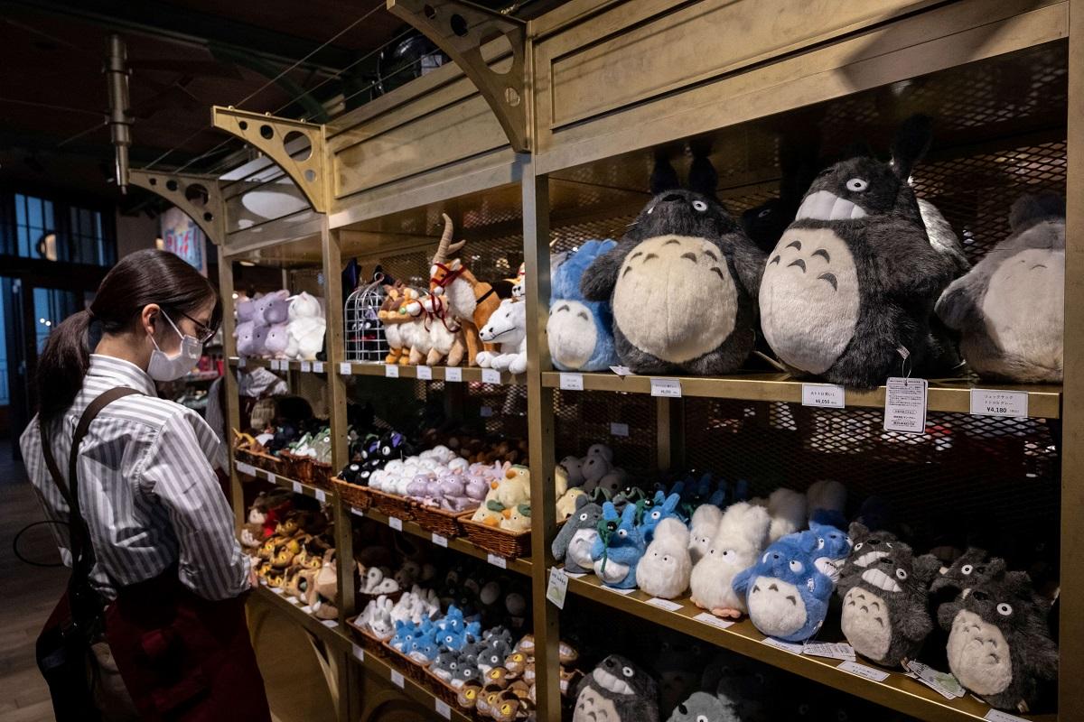 A member of staff works in a souvenir shop at Ghibli's Grand Warehouse during a media tour of the new Ghibli Park in Nagakute, Aichi prefecture on October 12, 2022. Yuichi Yamazaki/ AFP