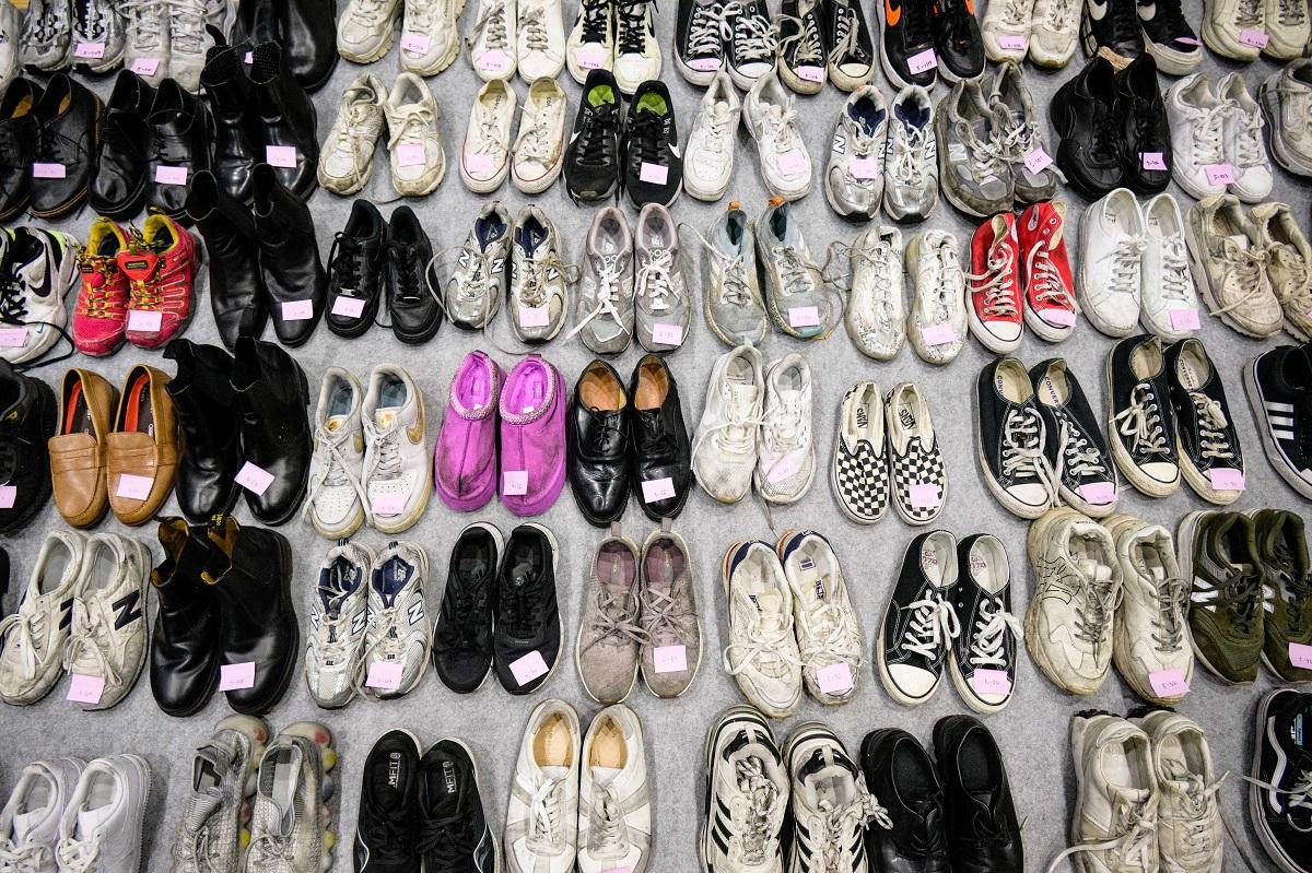 Shoes retrieved by police from the scene of a fatal Halloween crowd surge that killed more than 150 people in the Itaewon district are displayed at a gymnasium for relatives of victims to collect, in Seoul on November 1, 2022. Anthony Wallace/ AFP