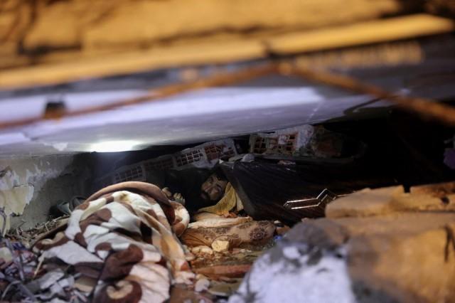 Abdulalim Muaini looks out from under the rubble in Hatay, Turkey, February 8, 2023. REUTERS/ Umit Bektas
