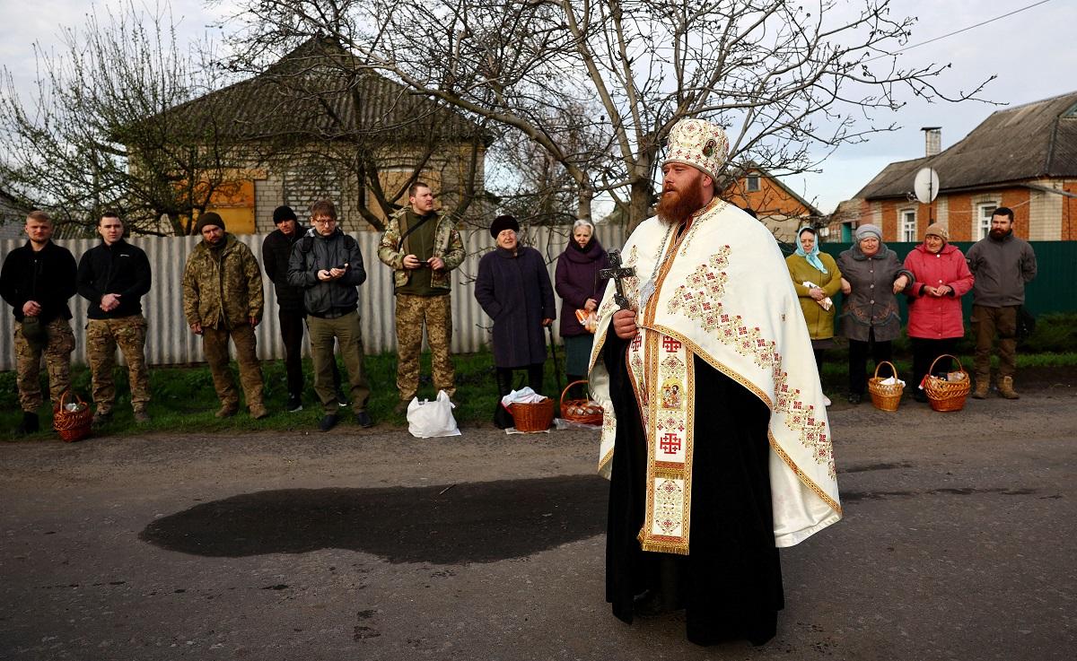 Ukrainian military chaplain Dionisii holds a service for servicemen and civilians to celebrate Orthodox Easter on the streets of Druzhkivka, Ukraine, April 16, 2023. In the eastern Orthodox Church, Easter is celebrated after Jewish Passover, which this year ended on April 13. REUTERS/ Kai Pfaffenbach