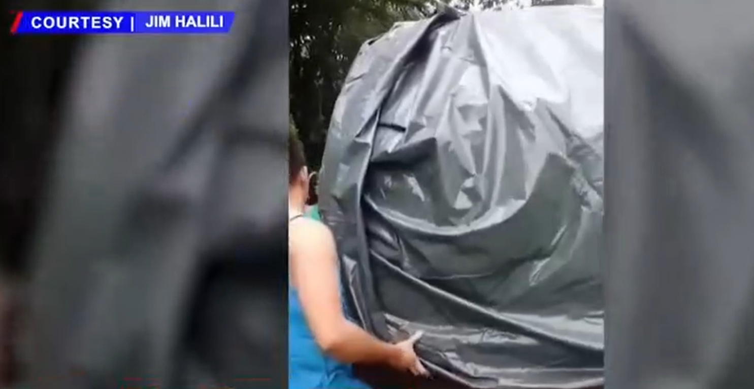 SUV floats in Calumpit flood after family wraps it in canvas thumbnail