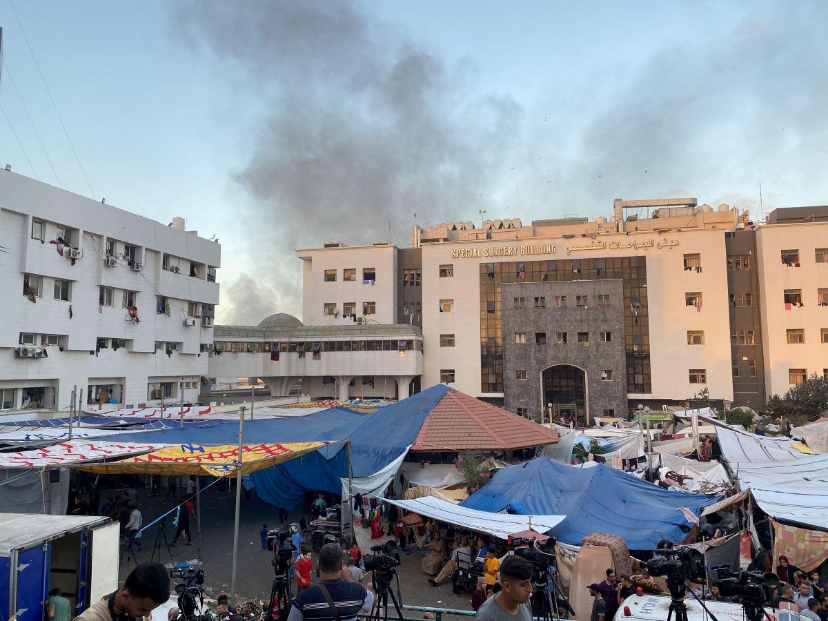 Smoke rises as displaced Palestinians take shelter at Al Shifa hospital in Gaza City