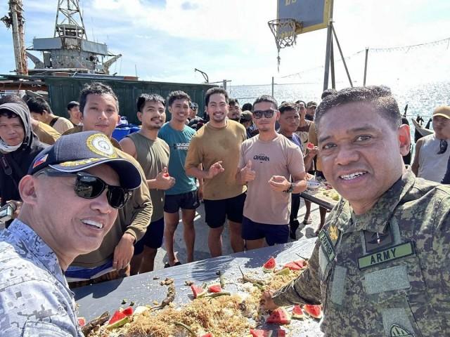 AFP Chief of Staff Gen. Romeo Brawner and AFP WesCom commander Vice Admiral Alberto Carlos join troops stationed at the BRP Sierra Madre at Ayungin Shoal on Dec. 10, 2023. Joseph Morong/GMA Integrated News 