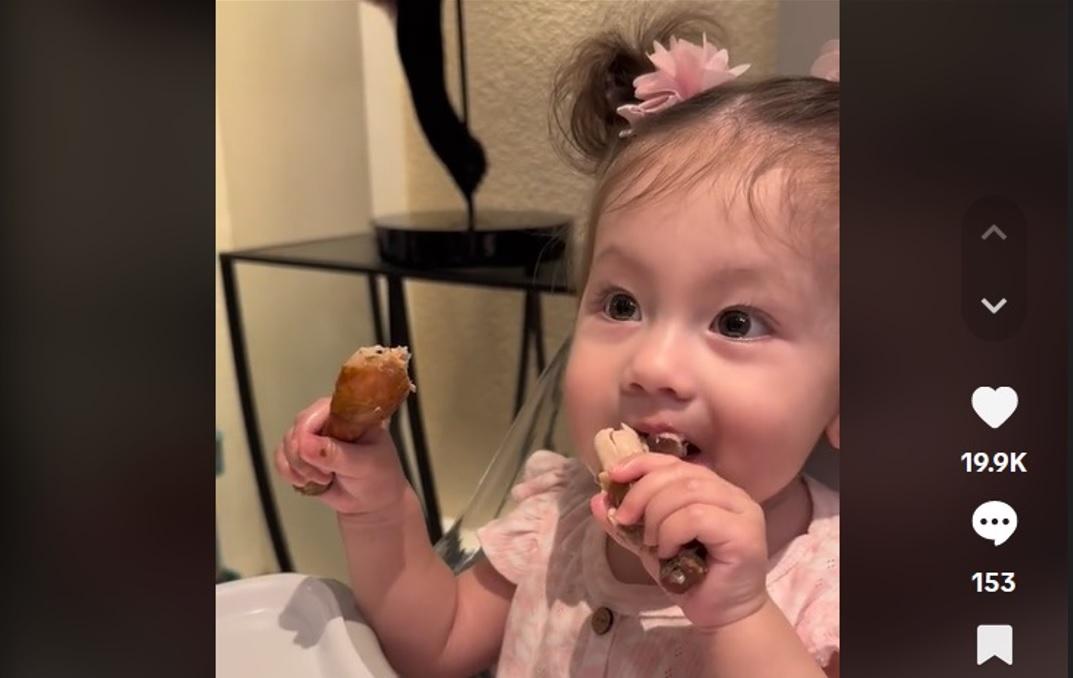 Baby Rosie enjoying chicken drumsticks