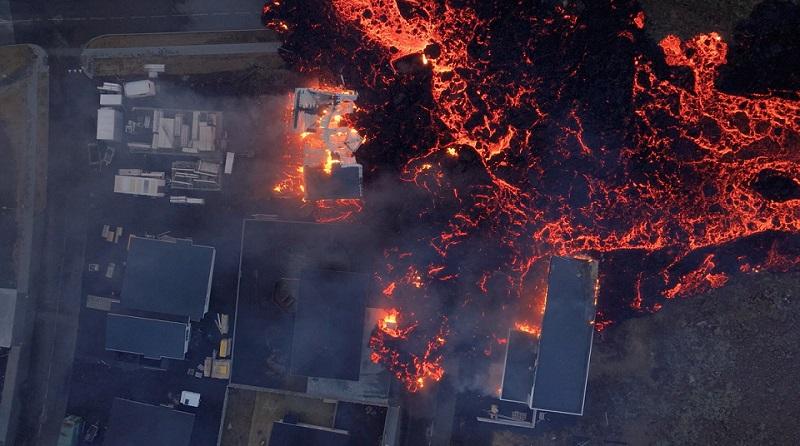 Lava flows from a volcano as houses burn in Grindavik, Iceland