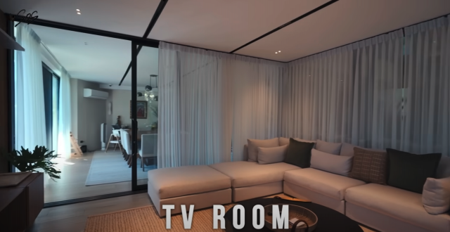 The TV Room follows the neutral color palette of the living area.