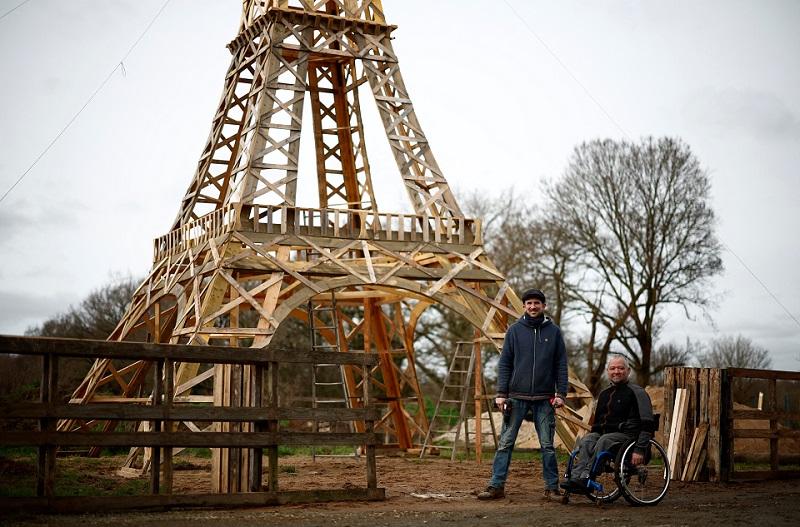 Two friends build Eiffel Tower from recycled wood ahead of Olympics thumbnail