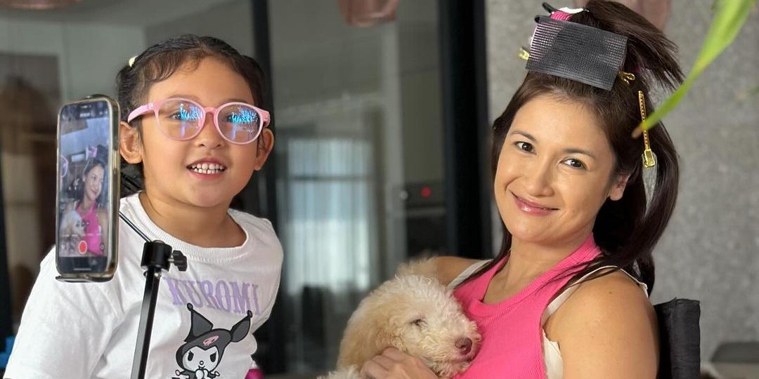 Camille Prats and family all smiles as they adopt a dog