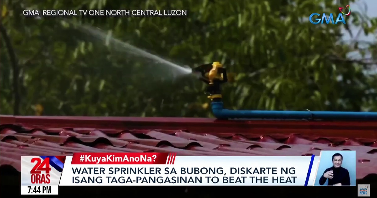 Technician from Pangasinan installs water sprinklers on his roof amid extreme heat