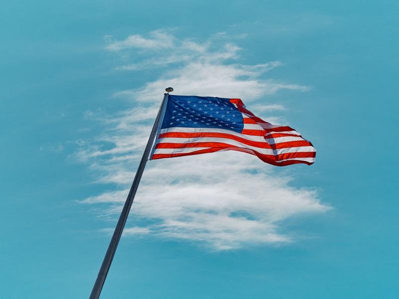 A US flag flutters at Moynihan Train Hall at Penn Station