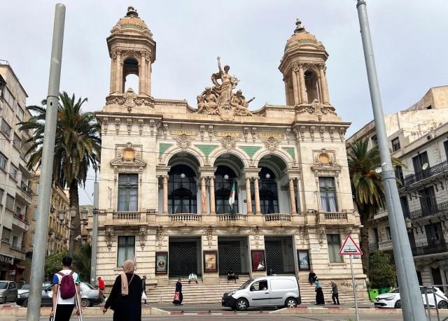People walk near the Regional Theater of Oran, in the city of Oran, Algeria May 23, 2024. REUTERS/ Abdelaziz Boumzar