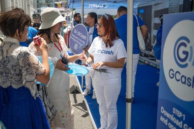 Filipinos abroad visit GCash booths which feature trade and travel merchants set up during a parallel street fair between Madison and Park Avenues.