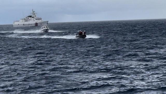 A Philippine Coast Guard rubber hull inflatable boat barrels through rough waters in an effort to elude a Chinese Coast Guard speedboat.