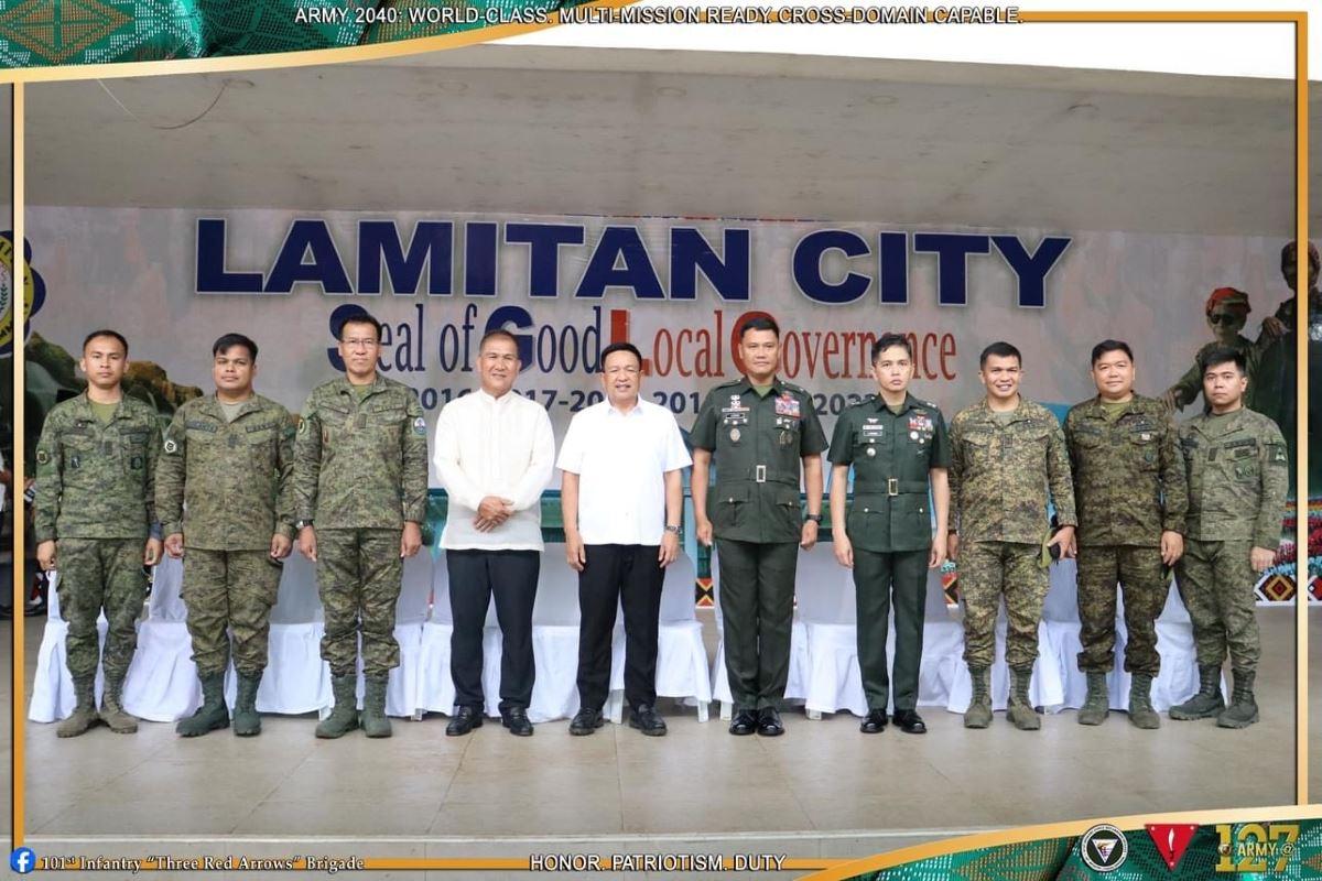 Provincial and local government executives and military officers at a ceremony in Lamitan City in Basilan on June 18, 2024