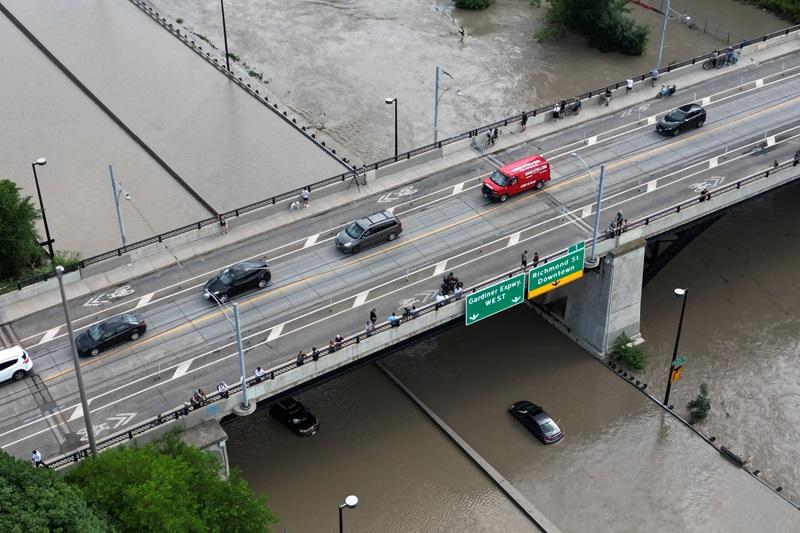Torrential rains flood Toronto, causing power outages, traffic disruption