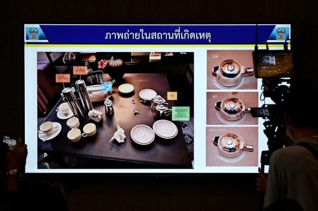 A screen shows a picture from the crime scene with teacups in which cyanide was found. REUTERS/ Chalinee Thirasupa