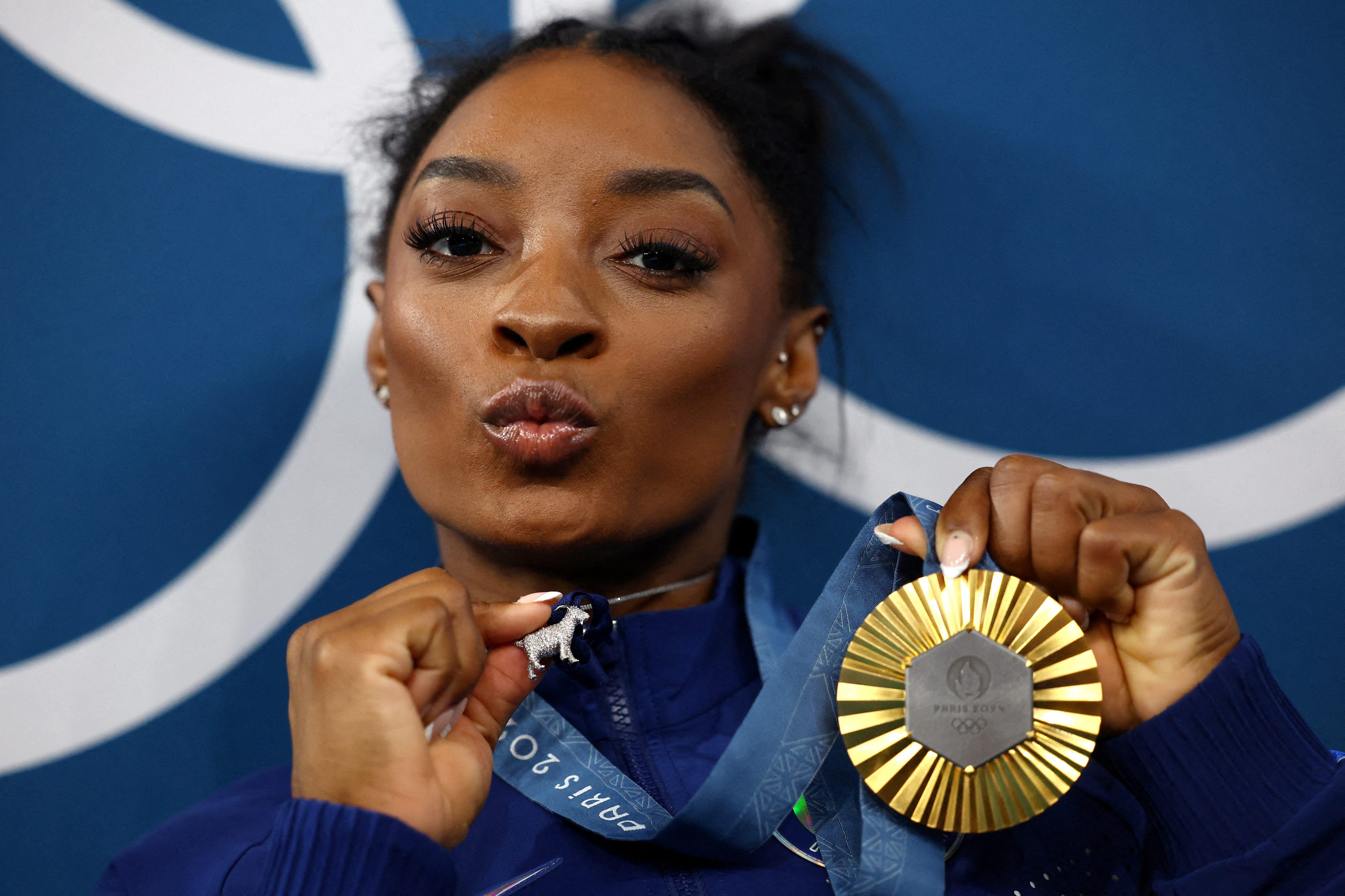 Simone Biles of the United States with one of her Olympic gold medals