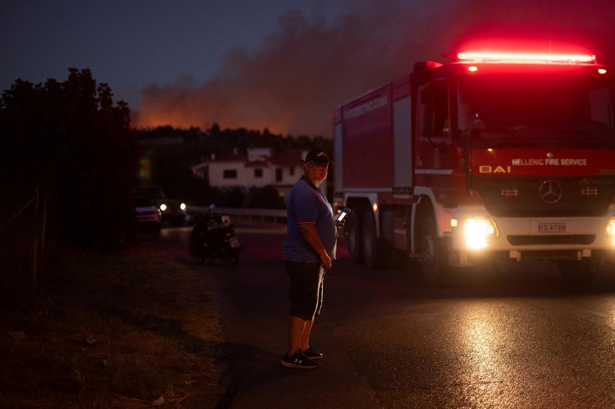 A wildfire burns in the village of Varnavas, near Athens