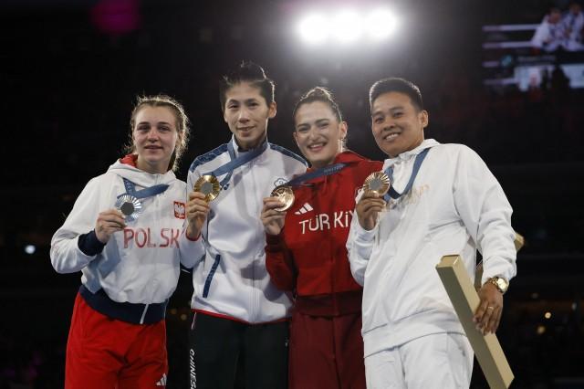Gold medalist Lin Yu-Ting of Taiwan, silver medalist Julia Szeremeta of Poland, bronze medalist Esra Yildiz Kahraman of Turkey and bronze medalist Nesthy Petecio of Philippines. REUTERS/Peter Cziborra
