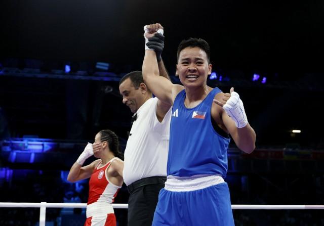 Paris 2024 Olympics - Boxing - Women's 57kg - August 02. Nesthy Petecio of Philippines celebrates as her hand is raised after winning her fight against Amina Zidani of France. REUTERS/Peter Cziborra