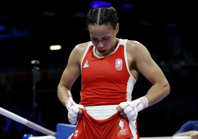 Paris 2024 Olympics - Boxing - Women's 57kg - Prelims - Round of 16 . Amina Zidani of France reacts after losing her fight against Nesthy Petecio of Philippines. REUTERS/Peter Cziborra