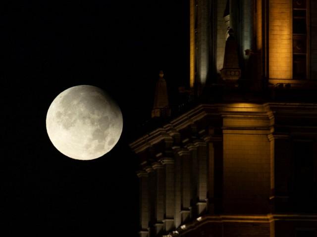 Partial lunar eclipse is seen next to a facade of a high-rise building in Moscow, Russia, September 18, 2024. REUTERS/Maxim Shemetov