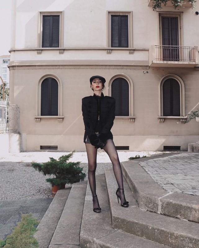 Heart slayed a daring look at the Dolce & Gabanna show with an all-black ensemble: a black jacket over a bra top and sheer lace matched with a pair of shorts and black stockings. She also sported a black hat with a net veil. Photo: Heart Evangelista/IG