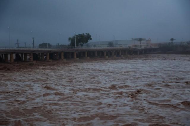River water churns, with a partially collapsed bridge seen in the background, after torrential rains caused flooding in the town of Carlet, Valencia region, Spain, October 30, 2024. REUTERS/ Eva Manez