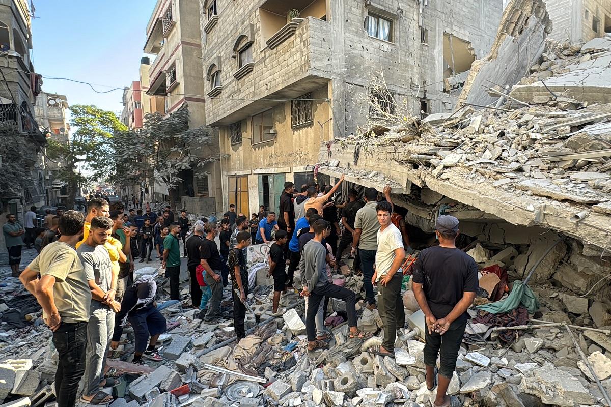 Palestinians inspect the damage after an Israeli airstrike the previous night in Beit Lahiya