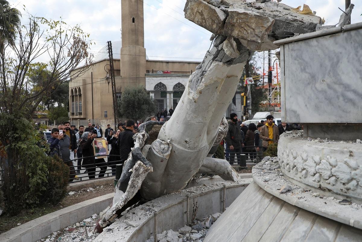 Syrians topple and trample on statues of Assad"s father