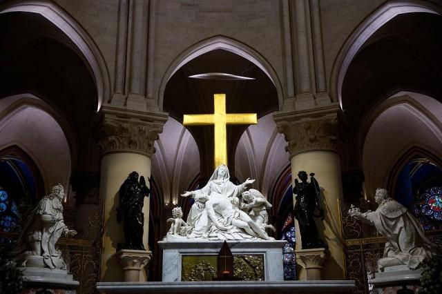 The golden Cross and the Statue of the Virgin of Pity or Pieta by Nicolas Coustou (1723). REUTERS/ Sarah Meyssonnier