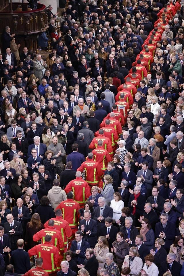 Firefighters, rescuers and builders involved in the restoration of Notre-Dame Cathedral parade during a ceremony to mark the re-opening of landmark cathedral, in central Paris, on December 7, 2024. Ludovic Marin/ Pool/ AFP