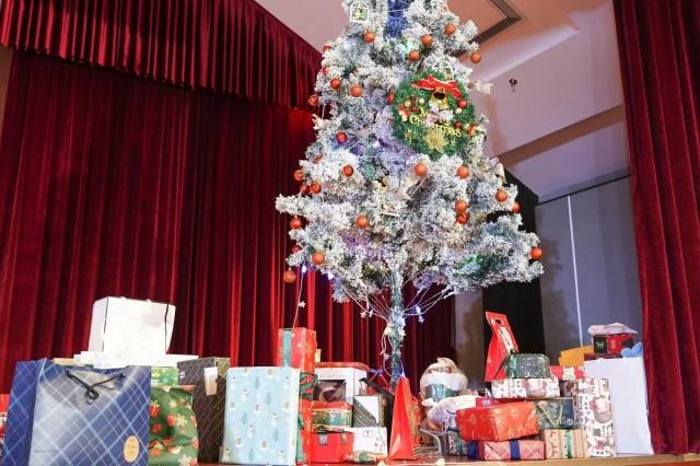 A Christmas tree graces the stage of the international school where 