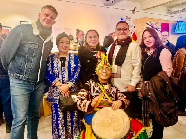 Philippine Ambassador Jaime Victor Ledda (second from right) and multi-disciplinary artist Django Valmores (seated) with guests at the 'Archipelago Abroad' exhibit in Brussels, Belgium in January 2025. Courtesy: Philippine Art and Culture Exchange (PACE)