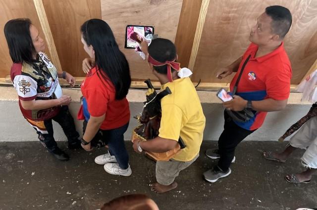 After hours standing in line, Ramil is finally able to touch his kerchief to the foot of the Nazareno through the small opening, designed by organizers to discourage kissing the image for hygiene reasons. Sherylin Untalan/GMA Integrated News