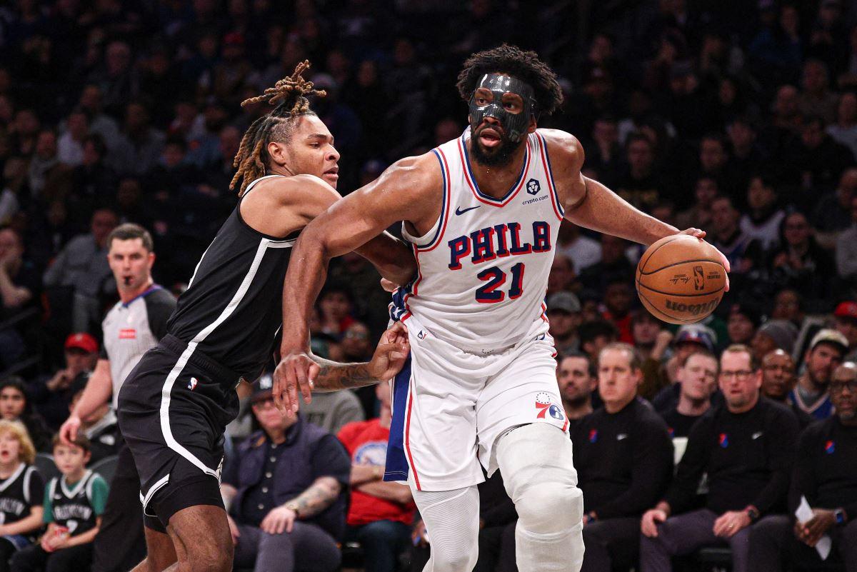 Philadelphia 76ers center Joel Embiid (21) is guarded by Brooklyn Nets forward Noah Clowney (21)