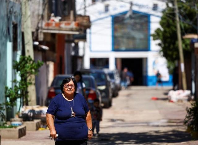 Rita Fernandez, 70, walks outside the Virgen de Caacupe chapel, where Pope Francis, then a young Jorge Mario Bergoglio used to visit regularly, at the Villa 21-24, in Buenos Aires, Argentina March 10, 2025. REUTERS/ Agustin Marcarian
