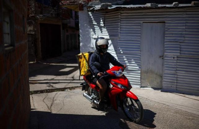 A delivery worker drives at the Villa 21-24, near the Virgen de Caacupe chapel, where Pope Francis, then a young Jorge Mario Bergoglio used to visit regularly, in Buenos Aires, Argentina March 10, 2025. REUTERS/ Agustin Marcarian