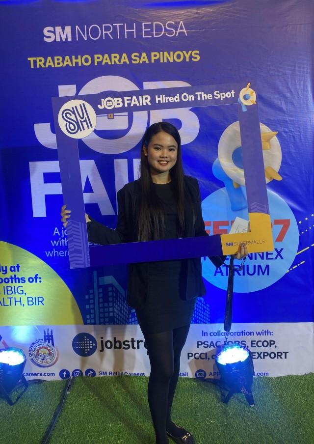 An applicant gets hired-on-the-spot during the SM Supermalls Job Fair.