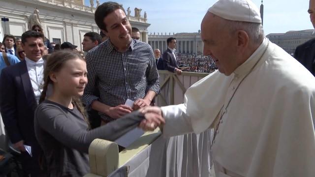 Climate activist Swedish teenager Greta Thunberg shakes hands with Pope Francis during the weekly audience at Saint Peter's Square at the Vatican in this still image taken from a video, April 17, 2019. Vatican Media/Handout via REUTERS