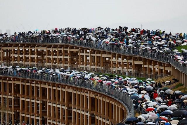 Visitors stand on the Grand Ring, the largest wooden architectural structure according to Guinness World Records, on Expo 2025's first day which is open to the public, in Osaka, western Japan April 13, 2025. REUTERS/ Issei Kato