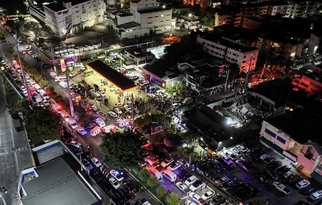 This handout picture released by Prensa Servicio 911 shows an aerial view of people gathering outside the Jet Set nightclub (R) after the collapse of its roof, in Santo Domingo, on April 8, 2025. Handout/ Prensa Servicio 911/ AFP