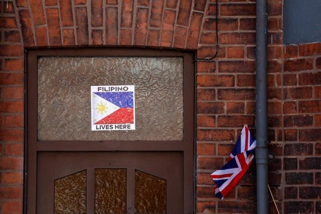 A view shows United Kingdom and Philippines flags placed on the door of a house, following riots in Ballymena, Northern Ireland, June 11, 2025. REUTERS/ Clodagh Kilcoyne