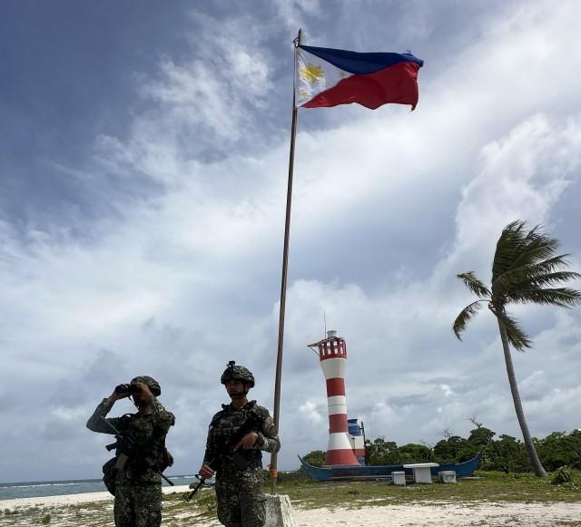 Armed members of the Philippine Marines stand ready to defend Likas from any attempt to take over the island.