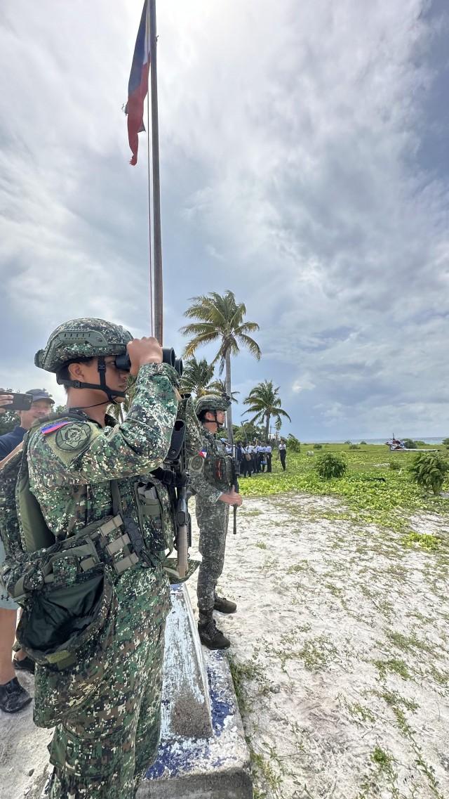 Philippine Marines scan the sea for any intruders while on duty at Likas Island./CHINO GASTON, GMA Integrated News