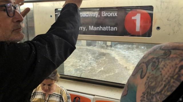 A man looks on from a subway as a station is flooded in New York City, July 14, 2025, in this screengrab obtained from a social media video. Juan Luis Landaeta/ via REUTERS